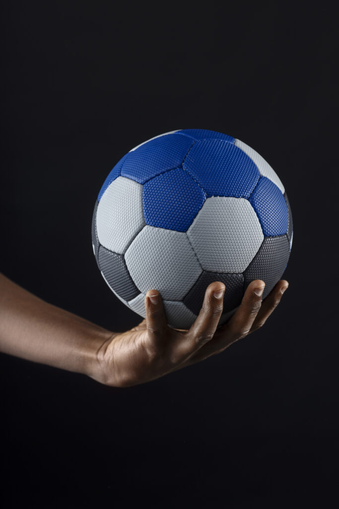 close up hand holding handball ball